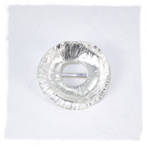 Round fold-form silver brooch